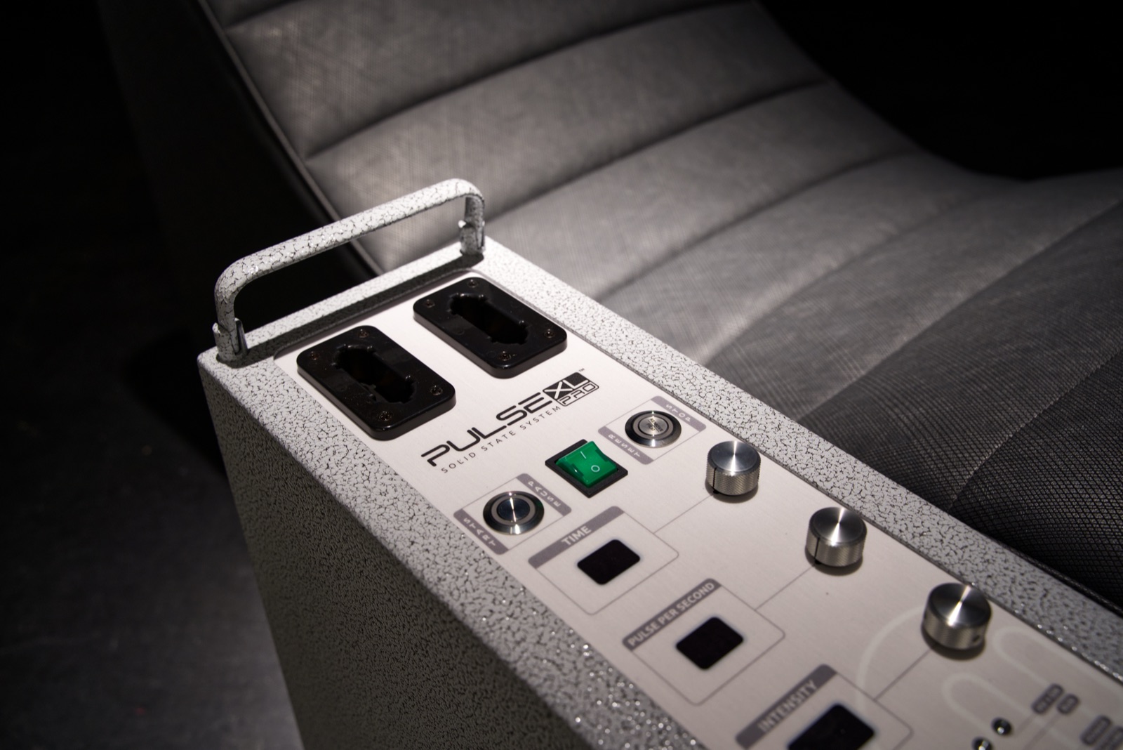 Close detail of the Pulse XL Pro control panel beside quilted Ultrafabrics upholstery