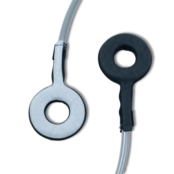 Two Pulse PEMF Power Ring accessories on a white background, one in white and one in black, each a padded ring-shaped applicator with a center opening and a zippered textured cover, attached to a gray cable.